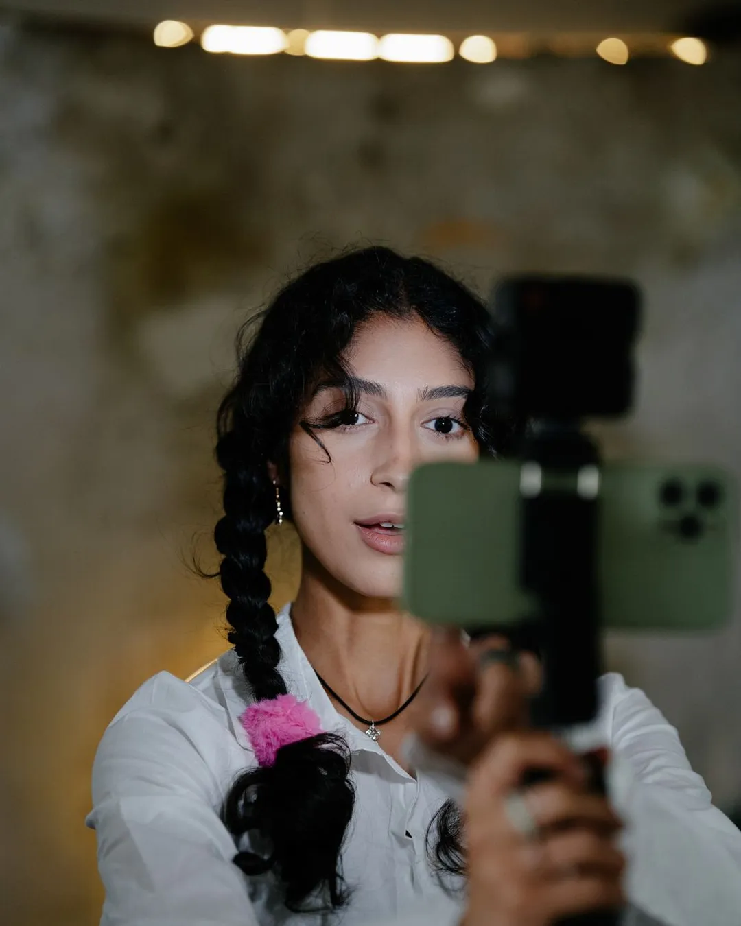 Creator filming a vertical smartphone video for TikTok